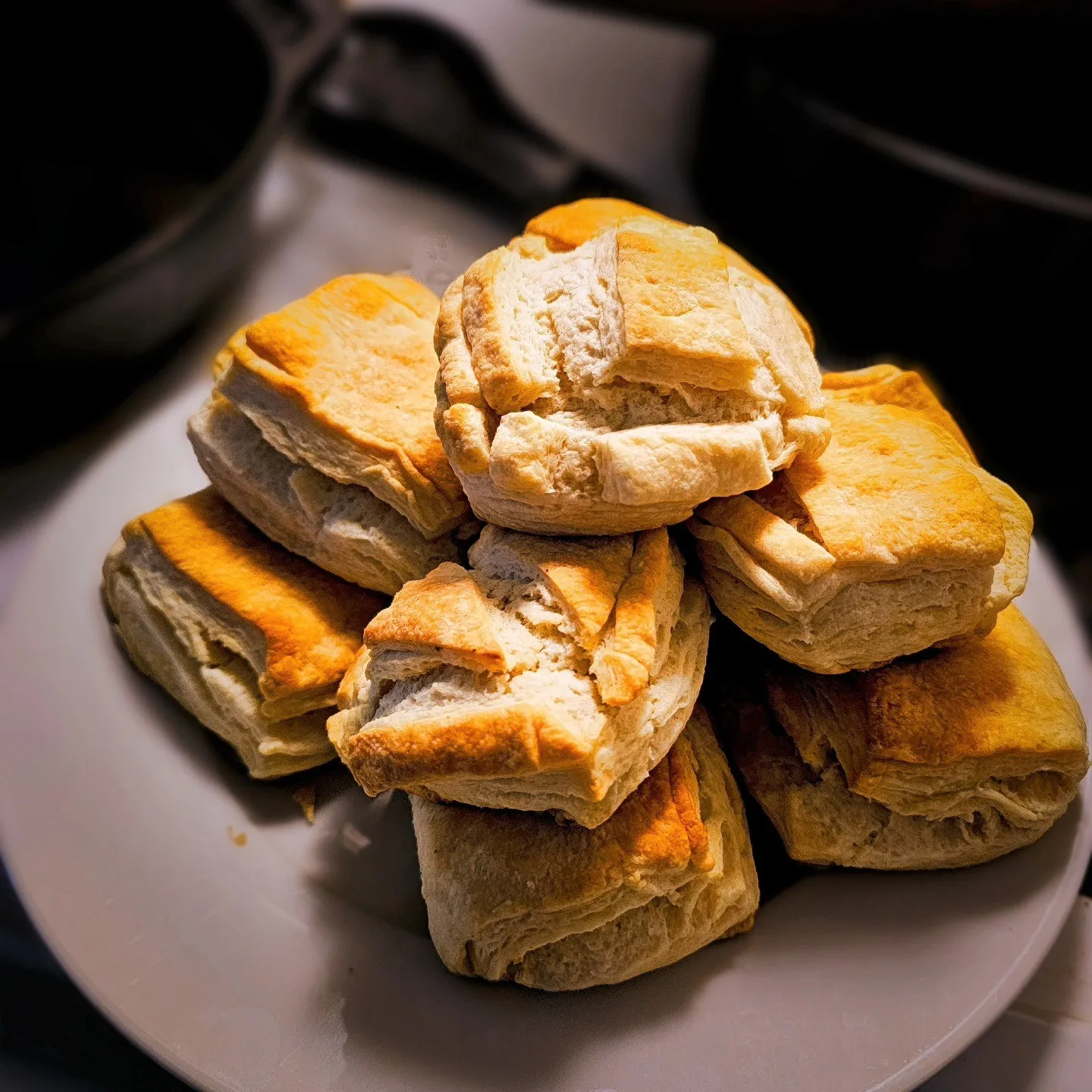 A plate piled with square, golden-brown biscuits.
